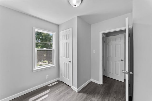 1205 E Parker Ave, Independence, MO 64050 - unfurnished bedroom featuring wood finished floors and a closet