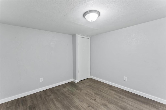 1205 E Parker Ave, Independence, MO 64050 - unfurnished room with dark wood-style floors and a textured ceiling