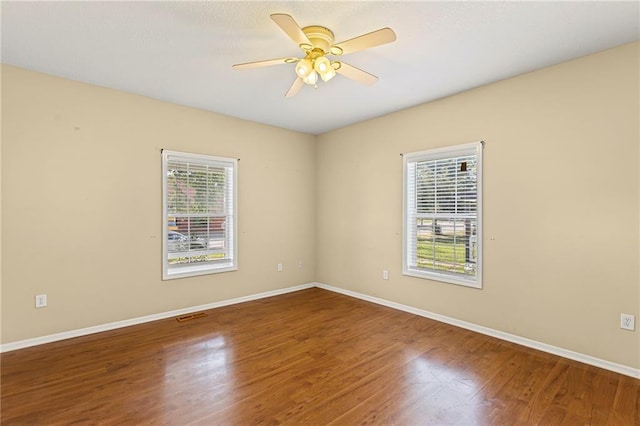 420 S Walnut St, Ottawa, KS 66067 - unfurnished room with healthy amount of natural light, wood finished floors, and a ceiling fan