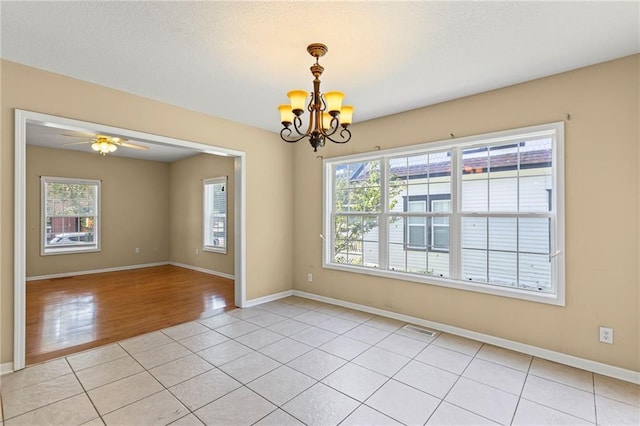 420 S Walnut St, Ottawa, KS 66067 - unfurnished room featuring healthy amount of natural light, a chandelier, light tile patterned flooring, and ceiling fan