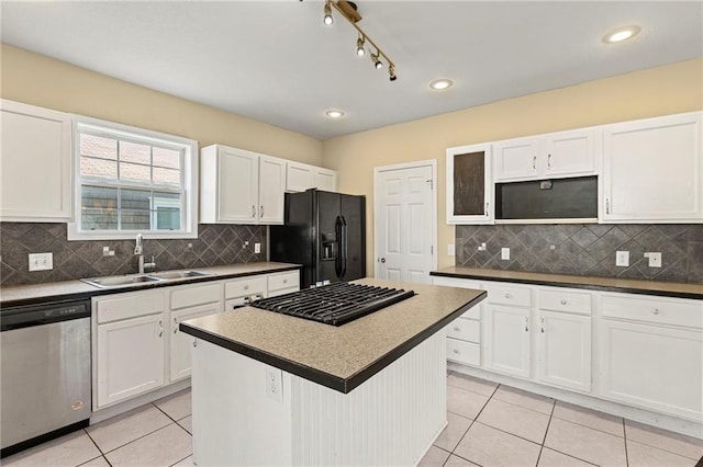 420 S Walnut St, Ottawa, KS 66067 - kitchen with stainless steel dishwasher, black refrigerator with ice dispenser, light tile patterned flooring, white cabinets, and recessed lighting