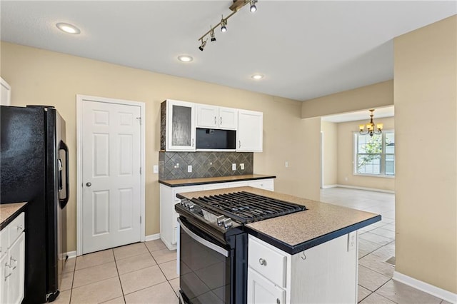 420 S Walnut St, Ottawa, KS 66067 - kitchen with range with gas cooktop, freestanding refrigerator, a chandelier, light tile patterned floors, and recessed lighting