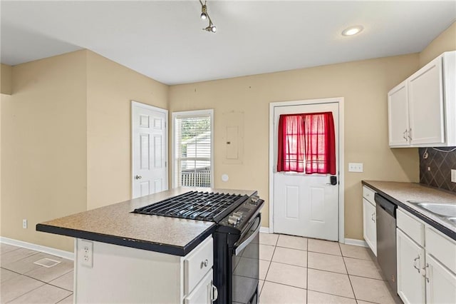 420 S Walnut St, Ottawa, KS 66067 - kitchen featuring black gas range, light tile patterned floors, stainless steel dishwasher, white cabinets, and recessed lighting