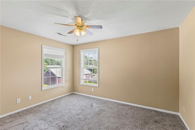 420 S Walnut St, Ottawa, KS 66067 - spare room featuring a ceiling fan, carpet, and a textured ceiling