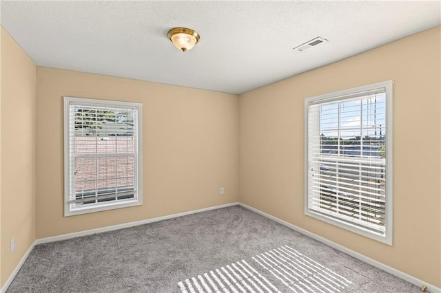 420 S Walnut St, Ottawa, KS 66067 - carpeted empty room with baseboards and a textured ceiling