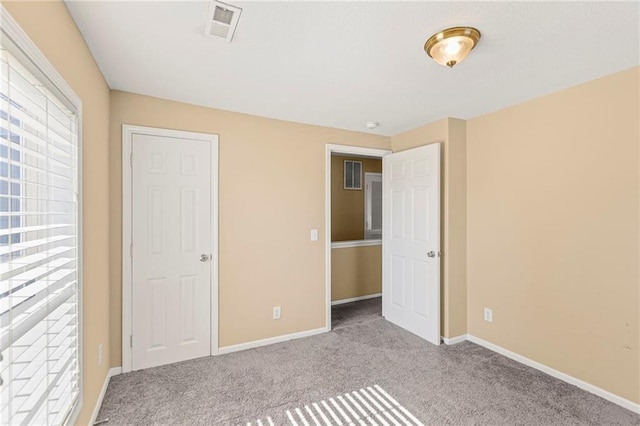 420 S Walnut St, Ottawa, KS 66067 - unfurnished bedroom with multiple windows and carpet floors