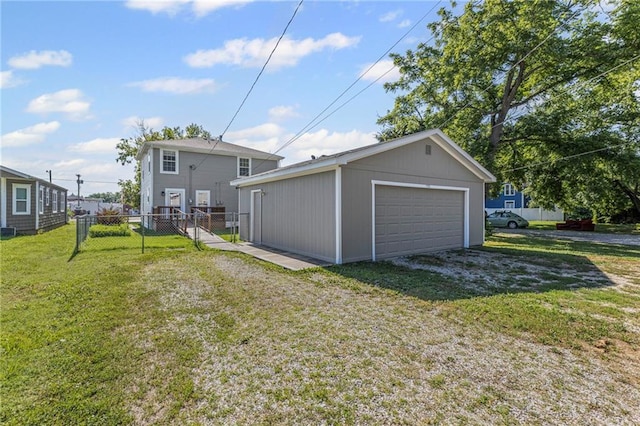 420 S Walnut St, Ottawa, KS 66067 - rear view of property featuring a detached garage and an outbuilding