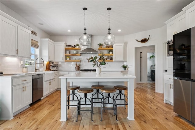 24328 W 58th Ter, Shawnee, KS 66226 - kitchen with stainless steel appliances, open shelves, wall chimney exhaust hood, light countertops, and decorative backsplash