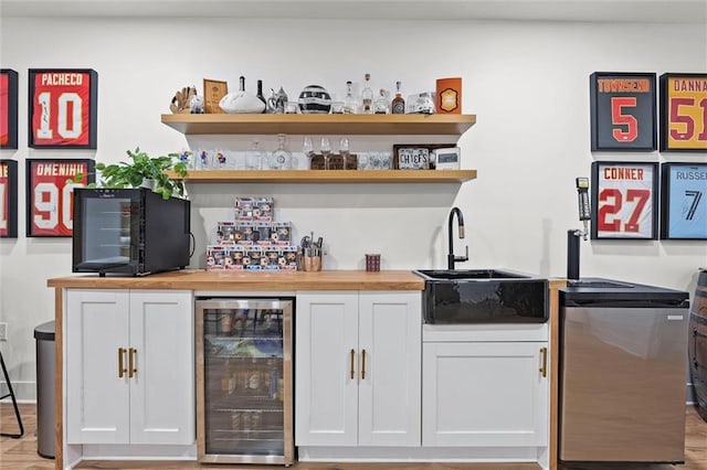 24328 W 58th Ter, Shawnee, KS 66226 - indoor wet bar featuring beverage cooler and light wood-type flooring