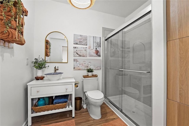 24328 W 58th Ter, Shawnee, KS 66226 - bathroom featuring wood finished floors, a shower stall, and vanity