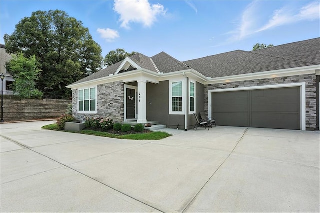 704 E 110th Ter, Kansas City, MO 64131 - ranch-style home featuring driveway, an attached garage, stone siding, and roof with shingles