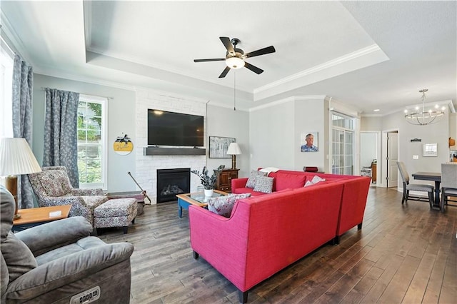 704 E 110th Ter, Kansas City, MO 64131 - living area featuring a tray ceiling, a ceiling fan, wood-type flooring, crown molding, and a chandelier