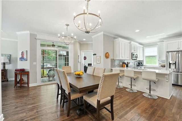 704 E 110th Ter, Kansas City, MO 64131 - dining room featuring dark wood-type flooring, crown molding, a chandelier, and recessed lighting