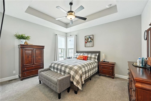 704 E 110th Ter, Kansas City, MO 64131 - bedroom with light colored carpet, a raised ceiling, and a ceiling fan