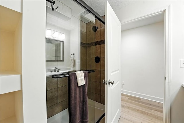 704 E 110th Ter, Kansas City, MO 64131 - full bathroom featuring a stall shower and wood finished floors