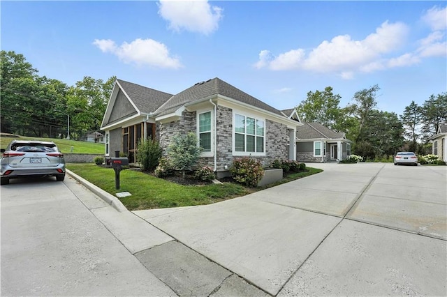 704 E 110th Ter, Kansas City, MO 64131 - view of home's exterior featuring stone siding and a yard