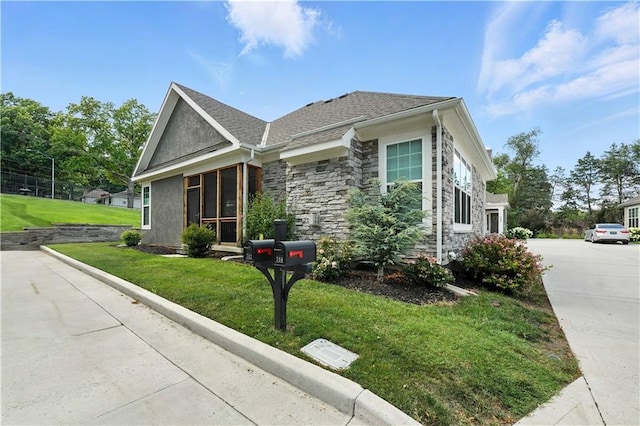704 E 110th Ter, Kansas City, MO 64131 - view of front of home featuring a front yard and stone siding