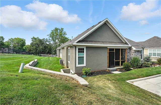 704 E 110th Ter, Kansas City, MO 64131 - rear view of property featuring stucco siding and a yard
