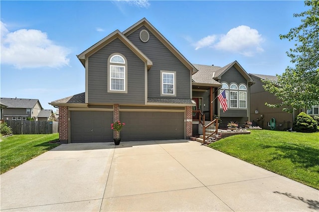 2353 SW Switchback Ct, Lees Summit, MO 64082 - view of front of house with brick siding, a garage, driveway, and roof with shingles