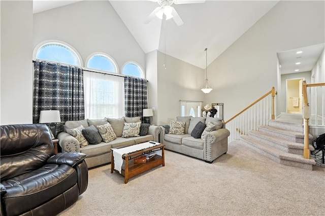 2353 SW Switchback Ct, Lees Summit, MO 64082 - carpeted living room featuring high vaulted ceiling, ceiling fan, and stairway
