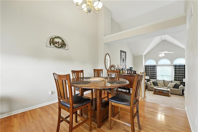2353 SW Switchback Ct, Lees Summit, MO 64082 - dining space with light wood-style floors, a chandelier, a ceiling fan, and high vaulted ceiling