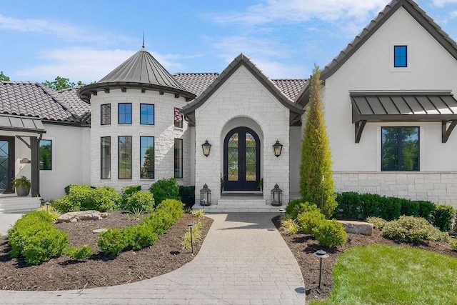 27497 W 108th St, Olathe, KS 66061 - view of front of property with french doors, stucco siding, and stone siding