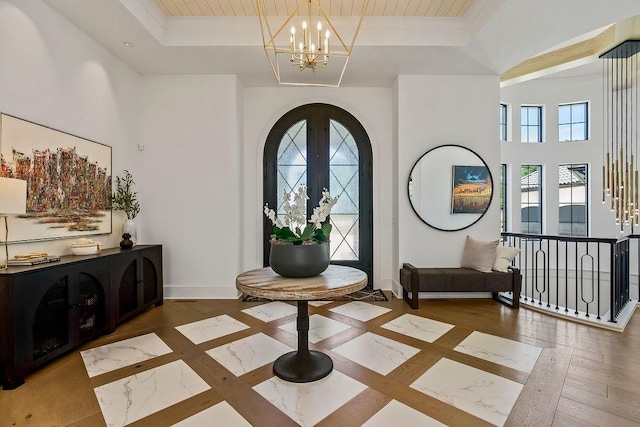 27497 W 108th St, Olathe, KS 66061 - entryway with a chandelier, a tray ceiling, arched walkways, wood finished floors, and wood ceiling
