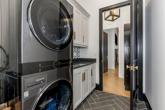 27497 W 108th St, Olathe, KS 66061 - washroom with stacked washer and clothes dryer and cabinet space
