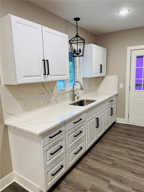 341 N 15th St, Kansas City, KS 66102 - kitchen featuring white cabinets, dark wood-type flooring, a chandelier, and light stone countertops