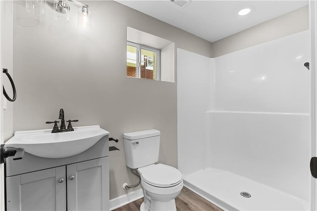 341 N 15th St, Kansas City, KS 66102 - bathroom featuring wood finished floors, vanity, and a shower