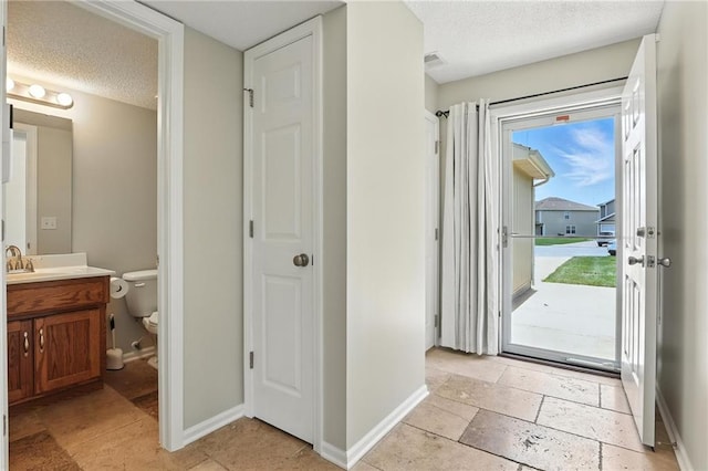 1501 SW Shelby Dr, Lees Summit, MO 64081 - entrance foyer with a textured ceiling and stone tile flooring
