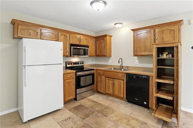 1501 SW Shelby Dr, Lees Summit, MO 64081 - kitchen with stainless steel appliances, brown cabinets, stone tile floors, light countertops, and a textured ceiling