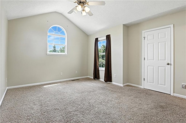 1501 SW Shelby Dr, Lees Summit, MO 64081 - unfurnished bedroom with carpet floors, vaulted ceiling, ceiling fan, and a textured ceiling