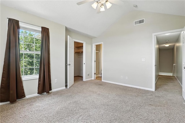 1501 SW Shelby Dr, Lees Summit, MO 64081 - unfurnished bedroom featuring carpet, lofted ceiling, a walk in closet, a ceiling fan, and a closet