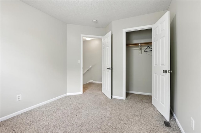 1501 SW Shelby Dr, Lees Summit, MO 64081 - unfurnished bedroom featuring carpet flooring, a closet, and a textured ceiling