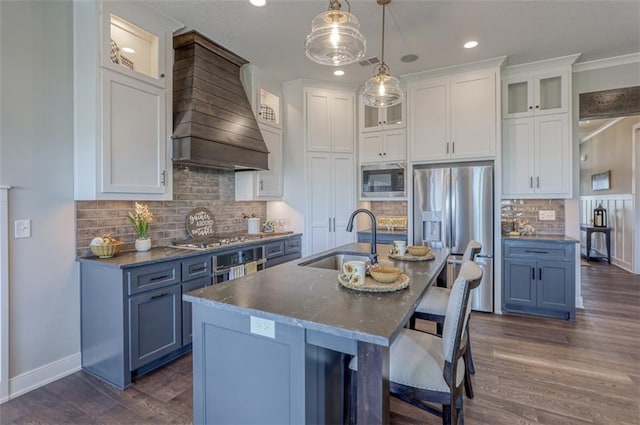 15389 W 173rd Ter, Olathe, KS 66062 - kitchen featuring stainless steel appliances, premium range hood, dark wood-type flooring, decorative backsplash, and white cabinetry