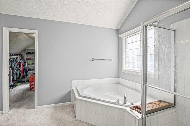 14510 W 138th Ter, Olathe, KS 66062 - bathroom featuring a textured ceiling, vaulted ceiling, a bath, a shower stall, and a walk in closet