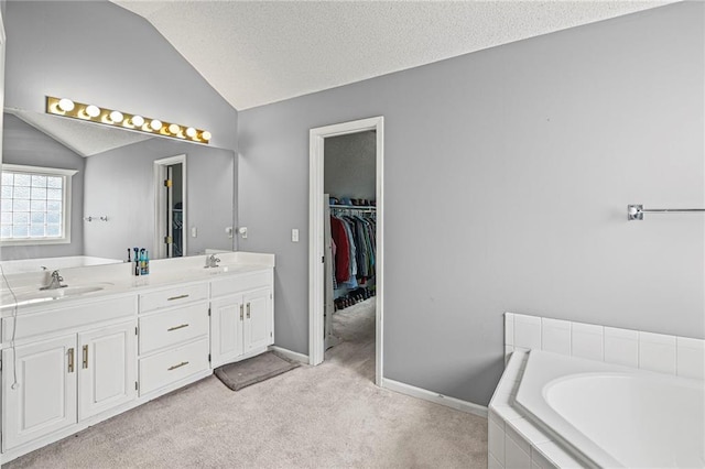 14510 W 138th Ter, Olathe, KS 66062 - full bath featuring vaulted ceiling, double vanity, a bath, and a textured ceiling