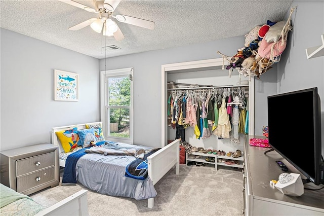 14510 W 138th Ter, Olathe, KS 66062 - bedroom with a closet, carpet floors, a textured ceiling, and ceiling fan
