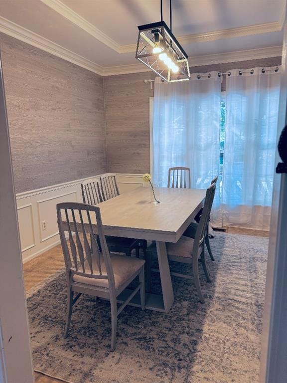 11328 S Rene St, Olathe, KS 66215 - dining area with crown molding, a decorative wall, wainscoting, and wood finished floors