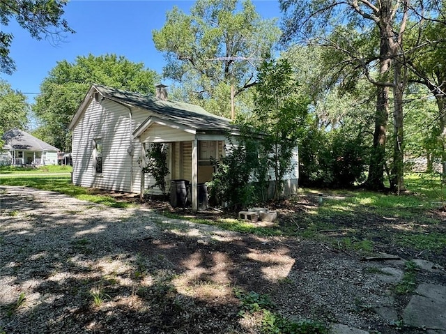 810 Center St, Pleasanton, KS 66075 - view of home's exterior with a chimney