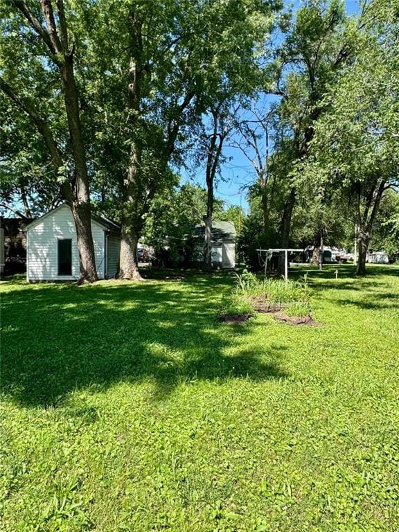 810 Center St, Pleasanton, KS 66075 - view of green lawn with an outbuilding