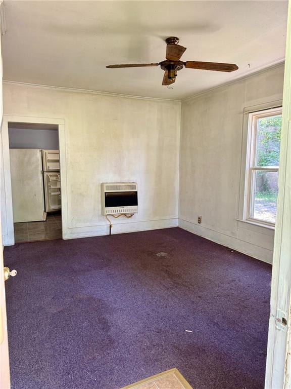 810 Center St, Pleasanton, KS 66075 - unfurnished living room featuring heating unit, ornamental molding, dark carpet, and a ceiling fan