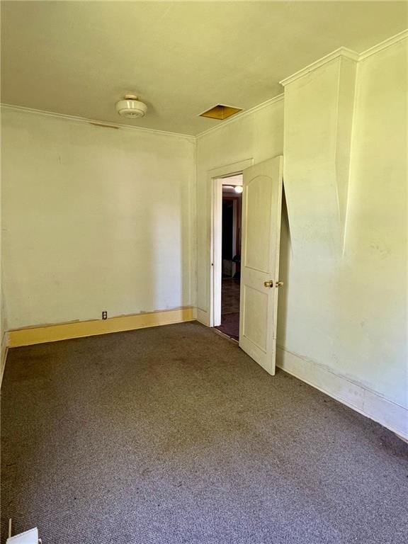 810 Center St, Pleasanton, KS 66075 - spare room featuring crown molding, dark colored carpet, and a smoke detector