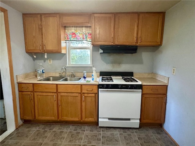 810 Center St, Pleasanton, KS 66075 - kitchen with white gas range, range hood, light countertops, and brown cabinetry