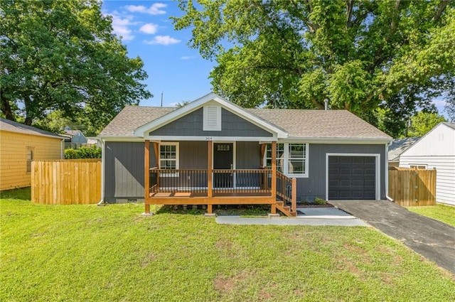 3414 Georgia Ave, Kansas City, KS 66104 - view of front of home with covered porch, an attached garage, driveway, and roof with shingles