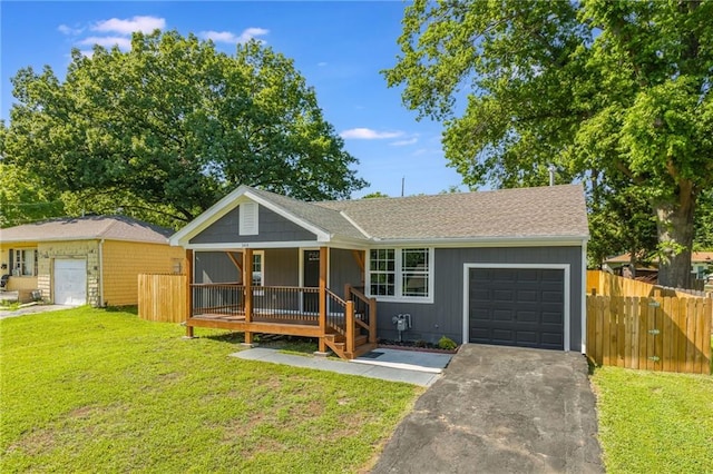 3414 Georgia Ave, Kansas City, KS 66104 - single story home with asphalt driveway, a garage, and covered porch