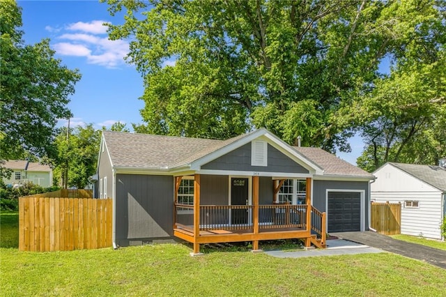 3414 Georgia Ave, Kansas City, KS 66104 - bungalow-style house featuring a garage, driveway, a porch, and roof with shingles