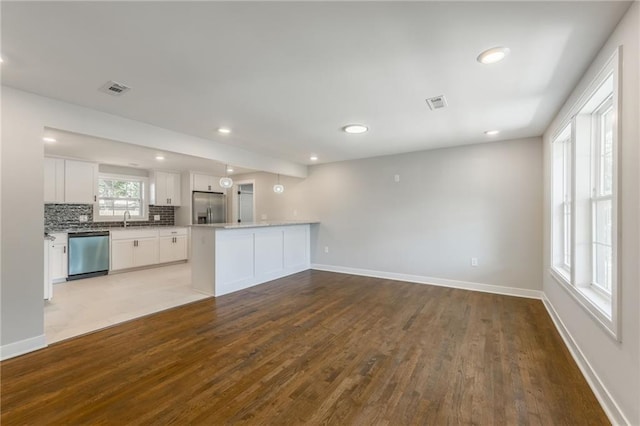 3414 Georgia Ave, Kansas City, KS 66104 - unfurnished living room featuring wood finished floors and recessed lighting