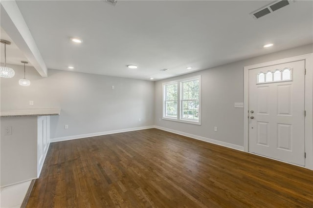 3414 Georgia Ave, Kansas City, KS 66104 - unfurnished living room featuring dark wood-type flooring and recessed lighting